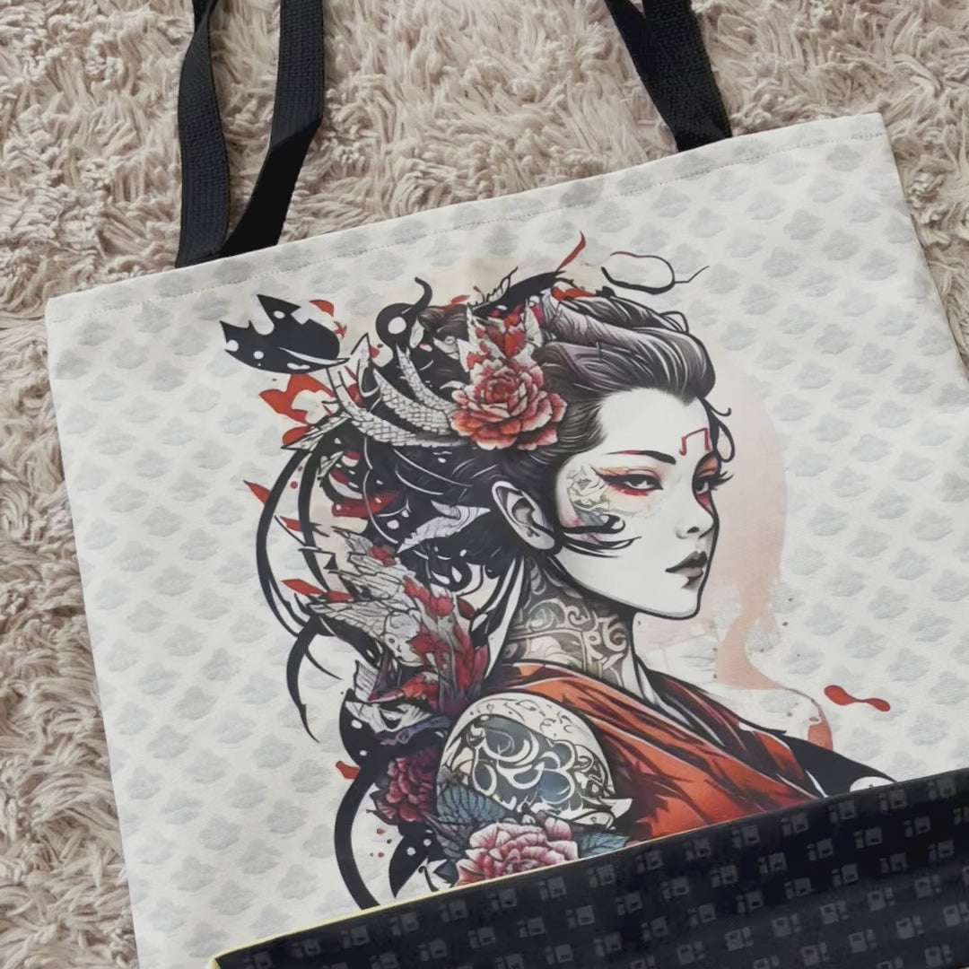 Sturdy canvas tote bag in white and black, adorned with a grey, repeating pattern and tattoo art depiction of a Japanese Geisha in a red sleeveless shirt with arm tattoos and flowers in her hair. Bag has two top straps and black accents along the bottom edge. Japanese Geisha Tote Bag, Tattoo Art Bag, Canvas Tote Bag, Sturdy Tote Bag, Black and White Tote Bag